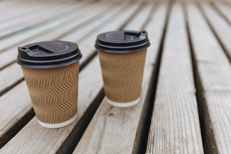 Brown ripple paper cups of hot aroma coffee with black lids.jpg